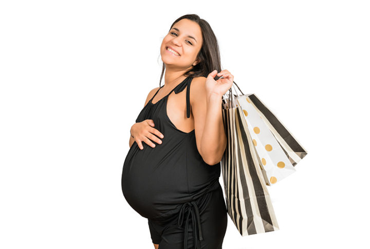 pregnant woman holding shopping bags